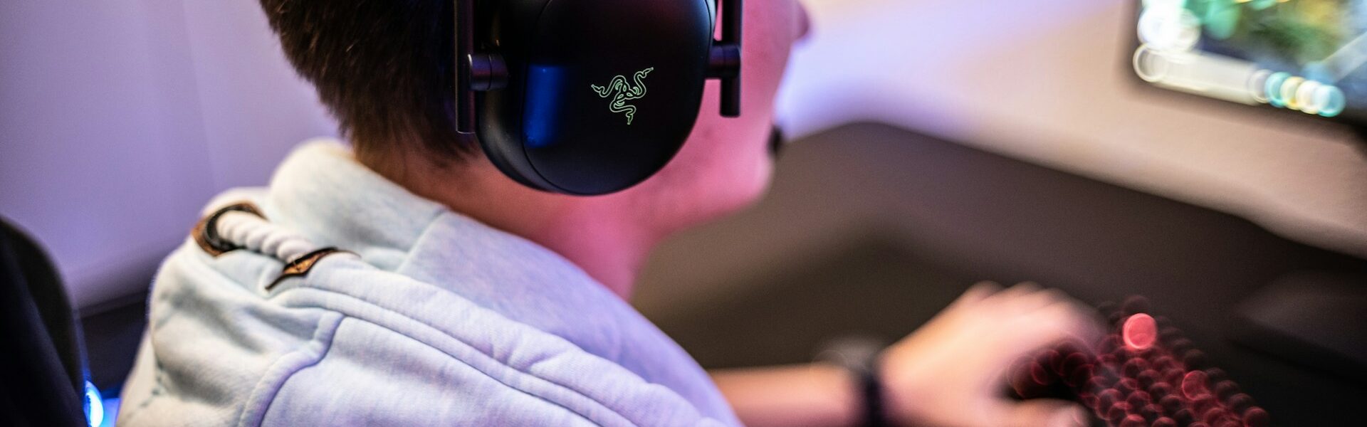 a man wearing Razer headset playing Killing Floor 3 on his PC