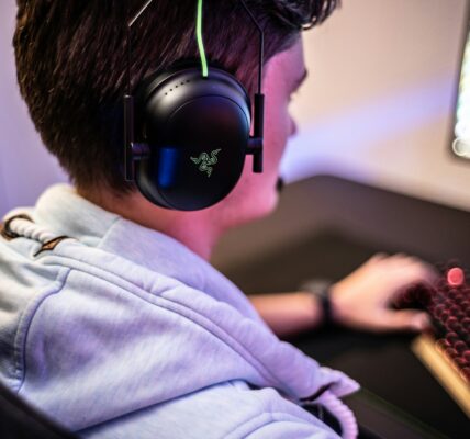 a man wearing Razer headset playing Killing Floor 3 on his PC