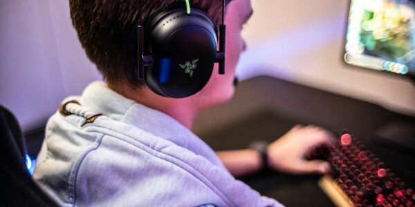 a man wearing Razer headset playing Killing Floor 3 on his PC