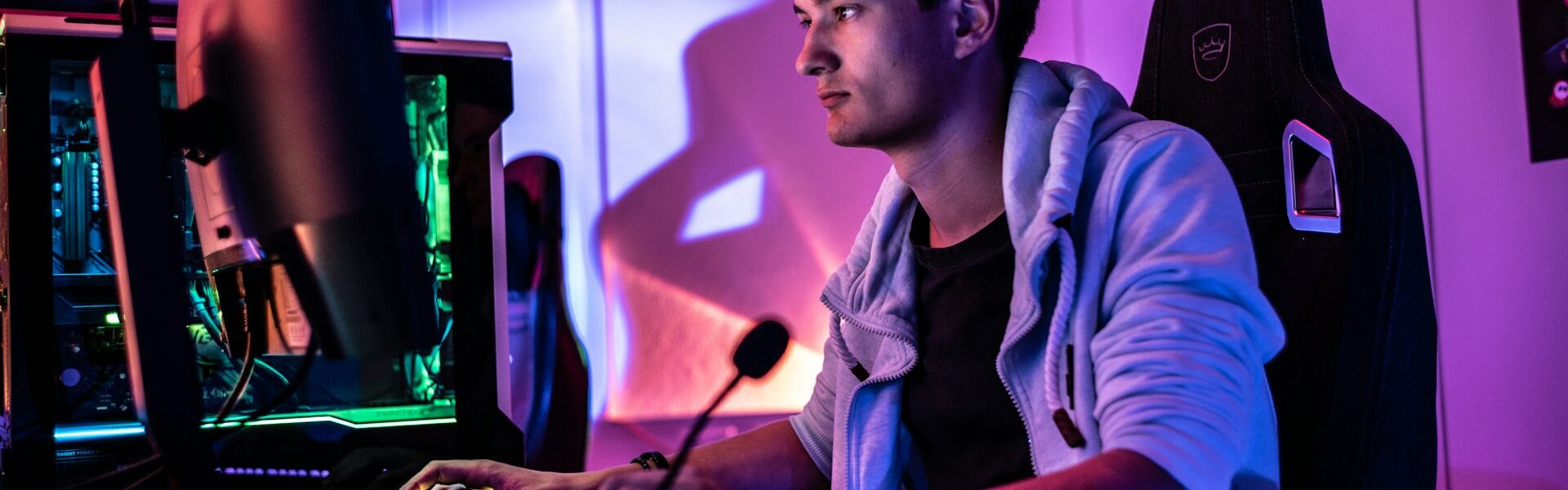 a man sitting behind his PC setup playing the new season of Diablo 4