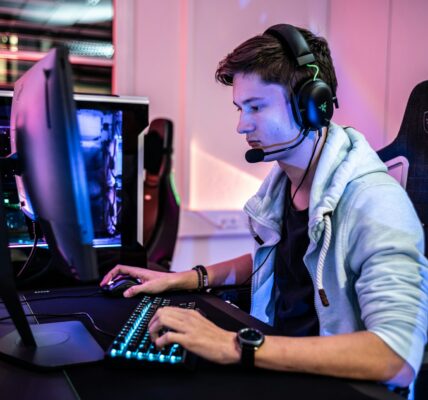 a person sitting in front of a computer playing video games like Kingdom Come: Deliverance 2 Image source: https://unsplash.com/photos/a-man-wearing-a-headset-and-using-a-computer-oPrXf-0Nf9Q