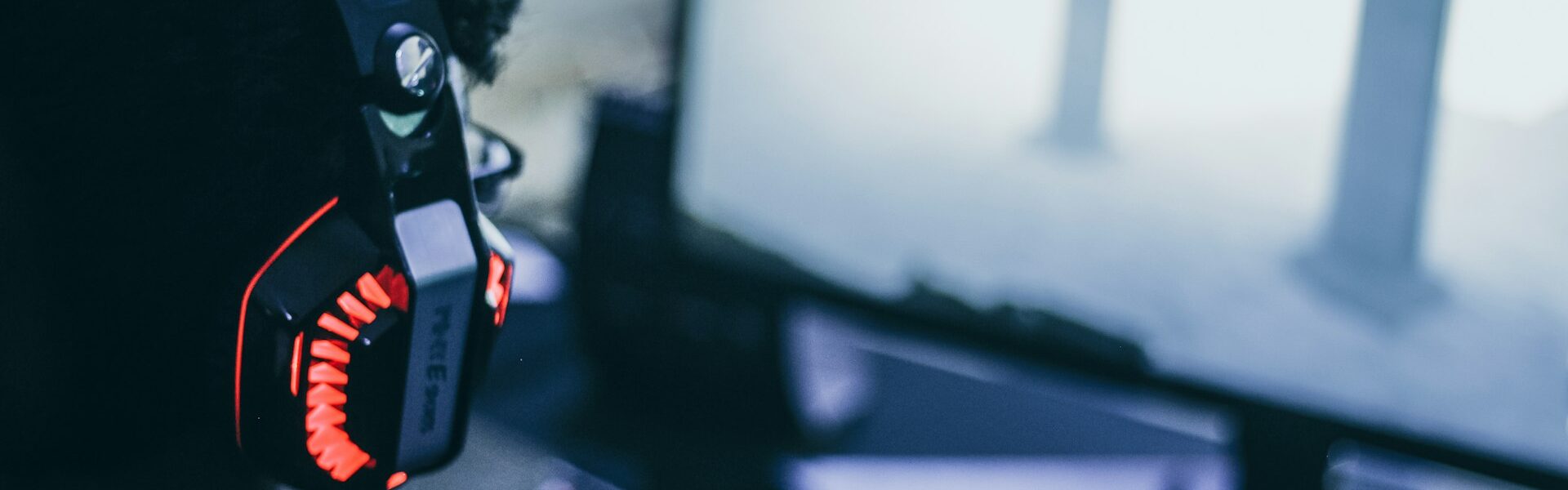 a person wearing headphones playing a S.T.A.L.K.E.R. 2 video game on their PC