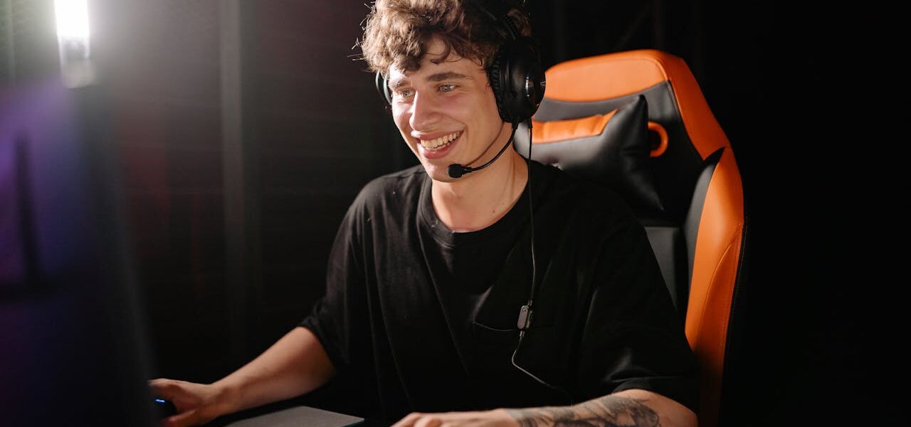 A man sitting in a gaming chair in front of a PC playing the new Civilization 7 game