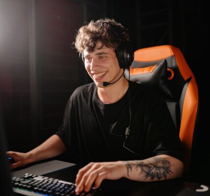 A man sitting in a gaming chair in front of a PC playing the new Civilization 7 game