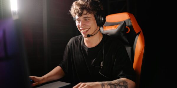 A man sitting in a gaming chair in front of a PC playing the new Civilization 7 game