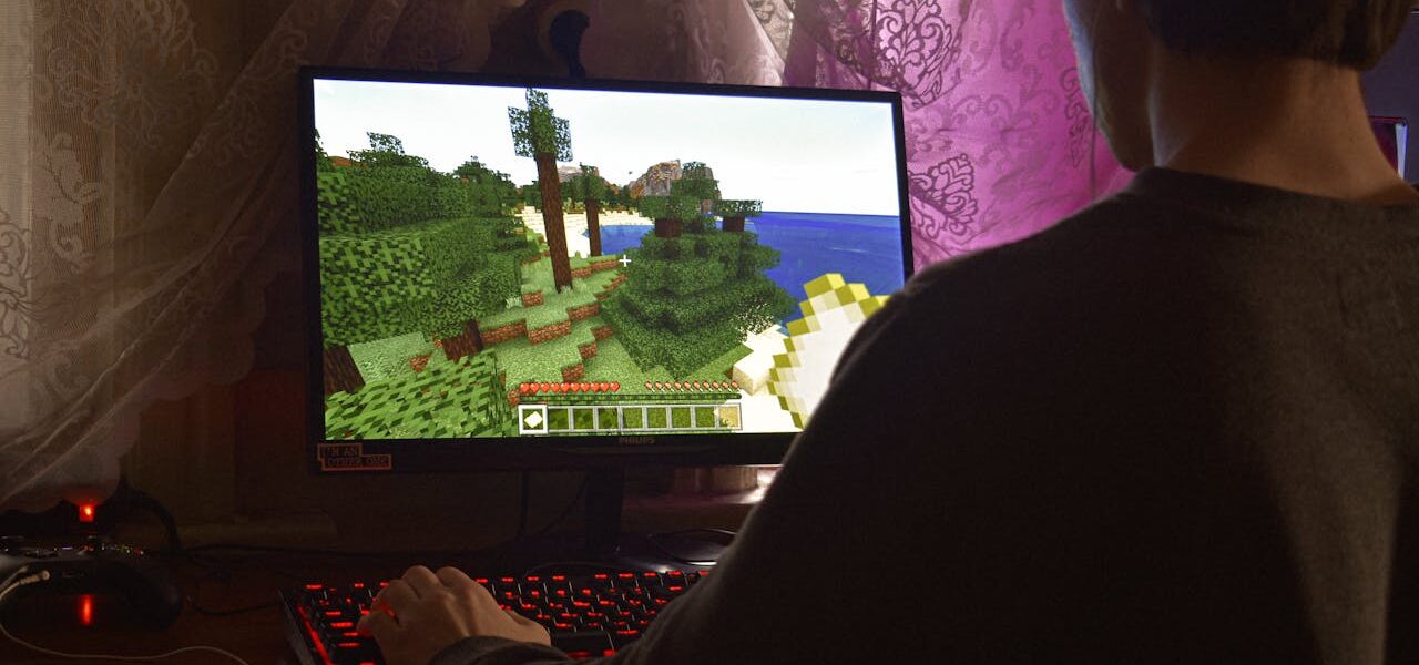 a man playing Minecraft on his PC