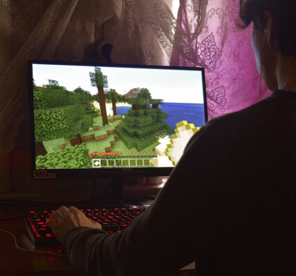 a man playing Minecraft on his PC