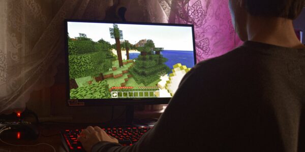 a man playing Minecraft on his PC