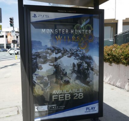 a billboard on the street that promotes Monster Hunter Wilds for Playstation 5
