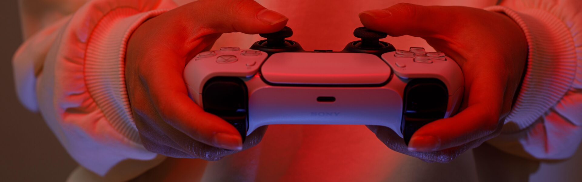 a person playing The Midnight Walk on Playstation 5 with red lights in the room