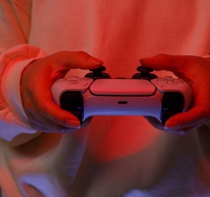 a person playing The Midnight Walk on Playstation 5 with red lights in the room