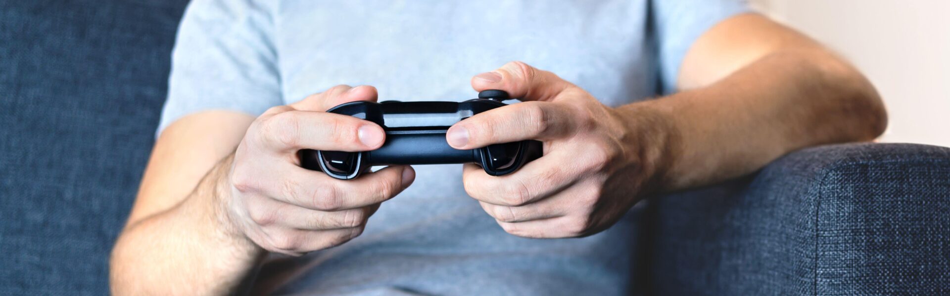 a man in a grey shirt playing Syberia Remastered on his Playstation