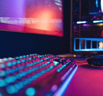 a PC setup with RGB lights with Nightreign playing on the monitor