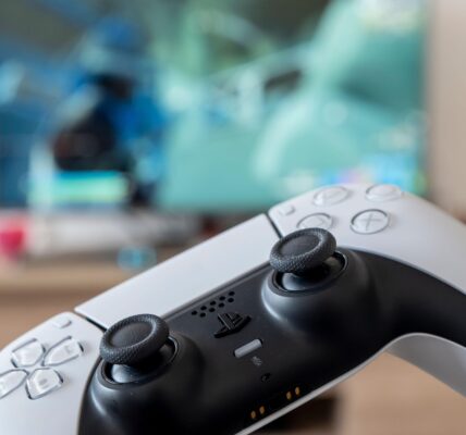 a person holding a white PS 5 controller with a video game on screen to represent the hype for Lost Soul Aside coming in August