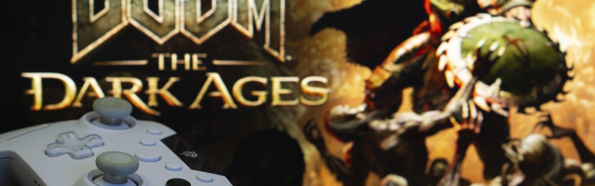 Doom: The Dark Ages on the TV with a white X Box controller in front of it