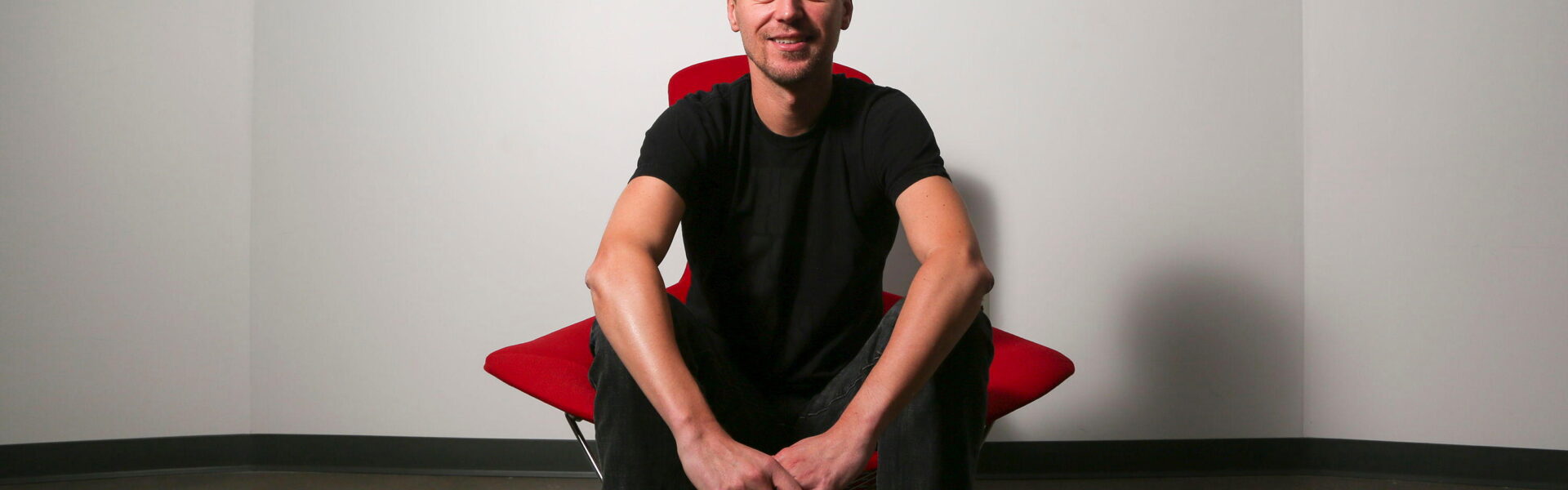 Christophe Balestra, co-president of Naughty Dog poses in front of the game studio logo