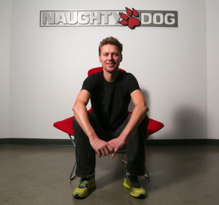 Christophe Balestra, co-president of Naughty Dog poses in front of the game studio logo