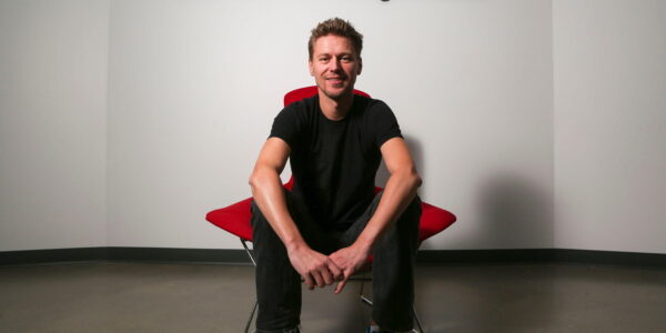 Christophe Balestra, co-president of Naughty Dog poses in front of the game studio logo