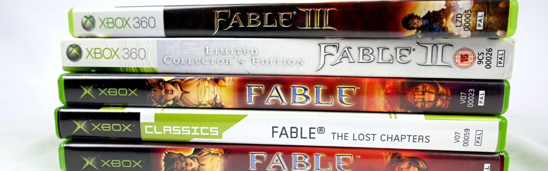 a stack of five different Fable games throughout the years to represent the hype for the newest release