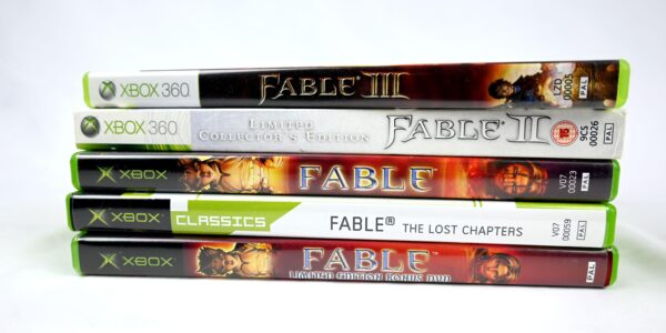 a stack of five different Fable games throughout the years to represent the hype for the newest release