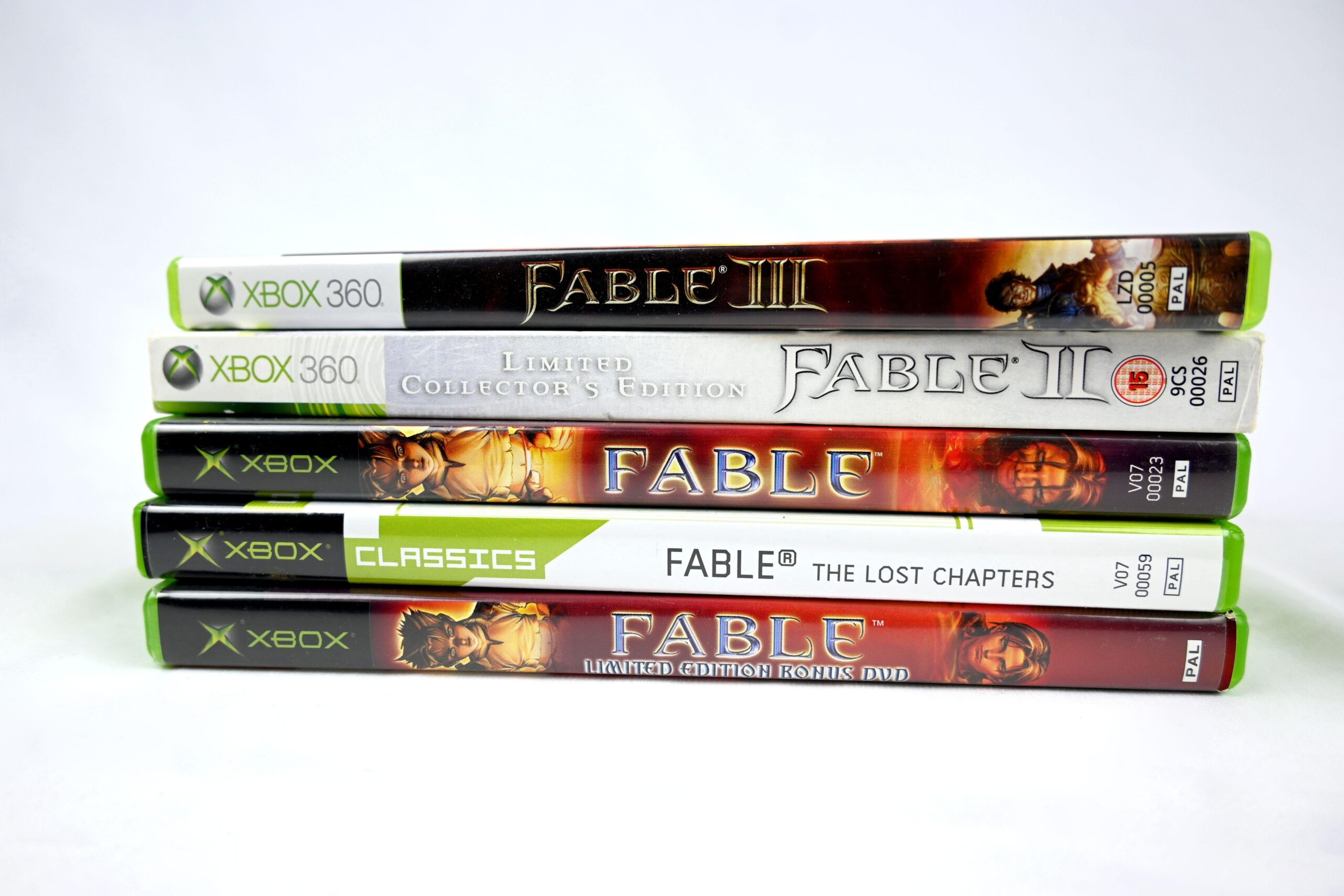 a stack of five different Fable games throughout the years to represent the hype for the newest release