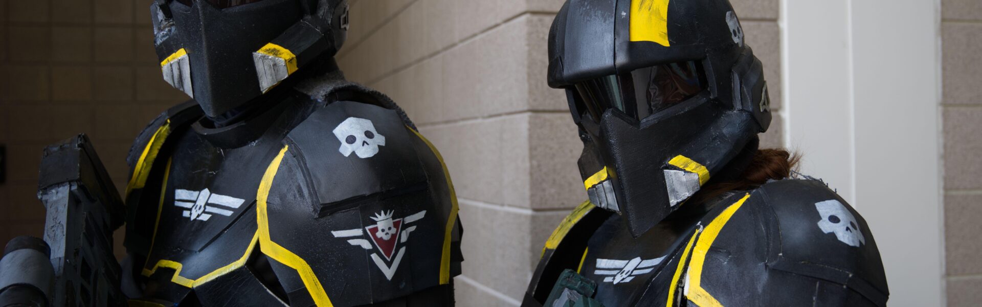 Two Helldivers 2 video game cosplayers in full armor suits